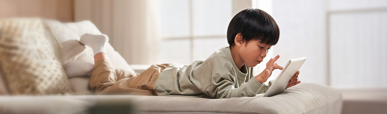 child scrolling AI videos on tablet in bed