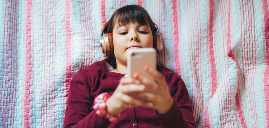 Teenage girl using smartphone with headphones