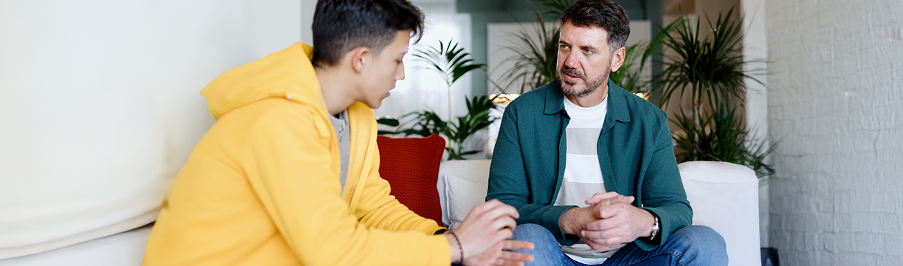 Father and teen son talking about screen time rules