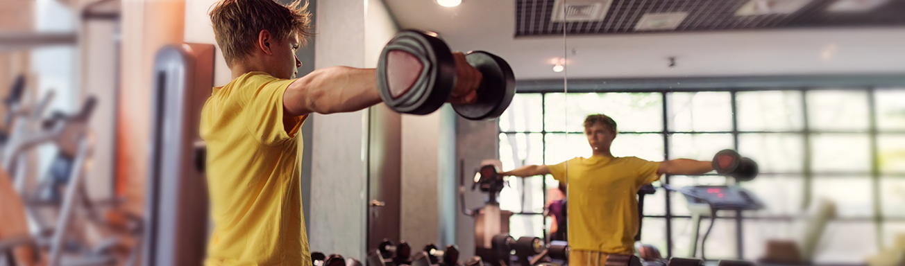 Teenage boy lifting weights