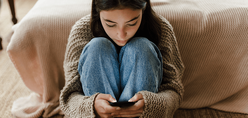 teen girl using smartphone alone